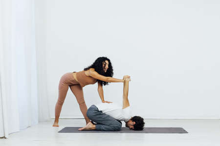 Man engaged in yoga with asana gymnastics fitness instructorの写真素材