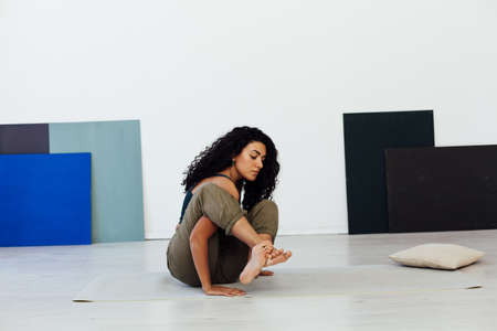 woman brunette engaged in yoga asana gymnastics flexibilityの写真素材