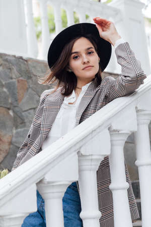 beautiful fashionable young woman in black hat with fieldsの写真素材