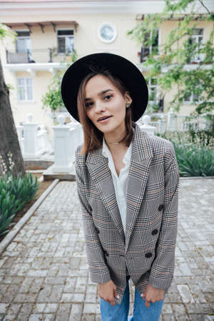 beautiful fashionable woman in black hat with fieldsの写真素材