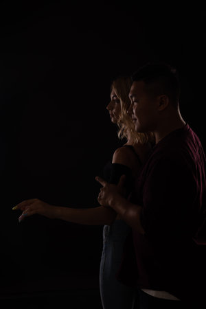 a man and a woman dance together to music in the dark