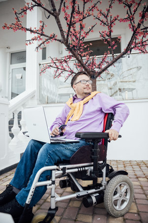 a man with a disability in a wheelchair looks at the view