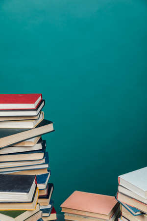 stacks of books for teaching knowledge of the university library green backgroundの写真素材