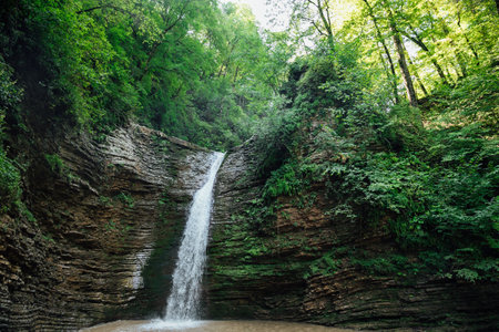 beautiful mountain waterfall in green forest landscape travelの写真素材