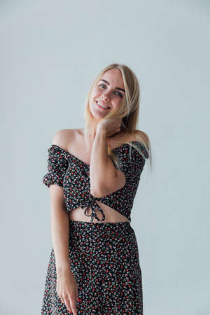 beautiful blonde woman in a gray dressの写真素材