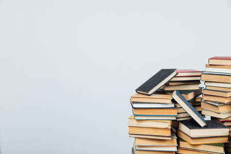 stacks of educational books in the college library on a white backgroundの写真素材