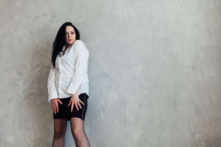 portrait beautiful fashionable woman brunette light backgroundの写真素材