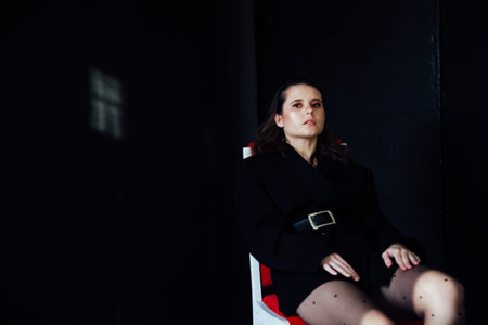 portrait of a beautiful fashionable brunette woman in a business suit