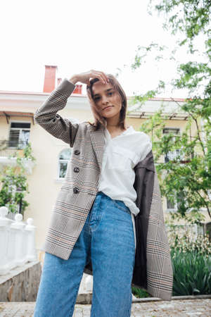 fashionable woman in a black hat walks around the cityの写真素材