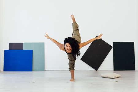 woman brunette engaged in yoga asana gymnastics exercises oneの写真素材