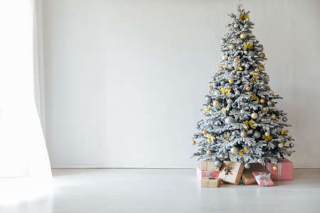 white snow-covered Christmas tree with gifts decorations new yearの写真素材