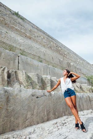 beautiful tanned woman in shorts and summer clothes stonesの写真素材