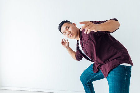 portrait of a male Asian dancer in a white hallの写真素材