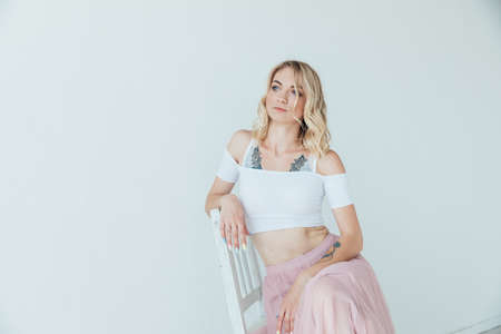 portrait of a beautiful blonde woman in a light summer dressの写真素材