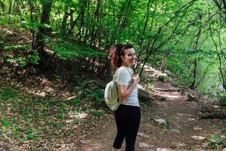 woman traveler in green forest hiking adventureの写真素材