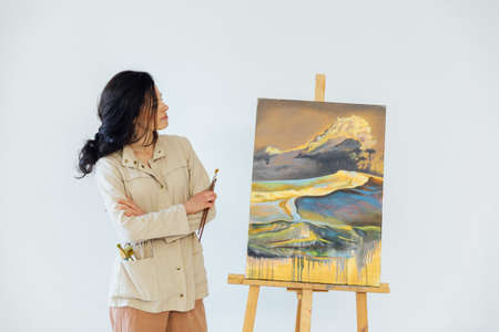 beautiful woman artist painted a picture with colorsの写真素材