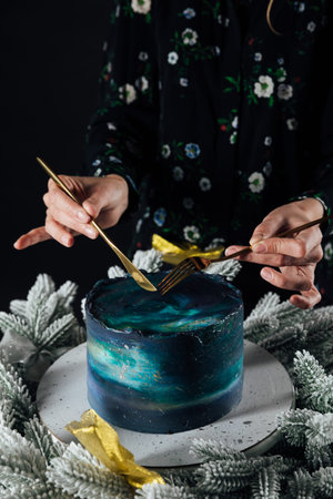 a woman cuts a sweet birthday cake for food