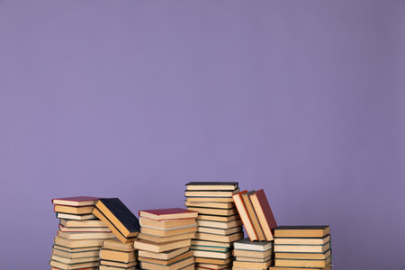 many books stacks on purple background in the library science college university trainingの写真素材