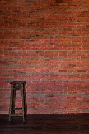 a one stool indoors against a brick wallの写真素材