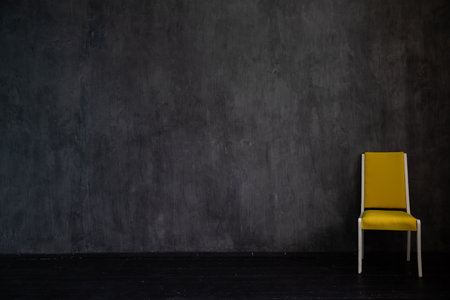 yellow chair in dark room interior furnitureの写真素材