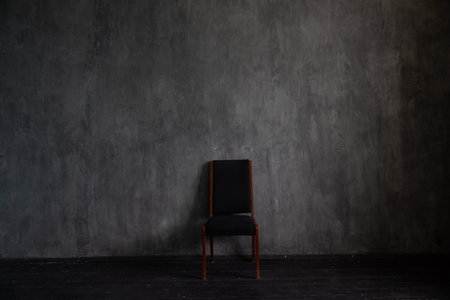One black vintage chair in the interior of an empty dark roomの写真素材