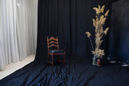 chair and decorative flowers on a black backgroundの写真素材