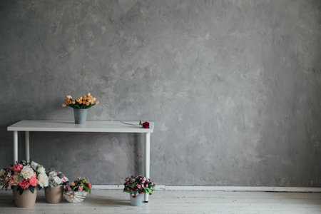 interior table with flowers in the room against the gray wallの写真素材