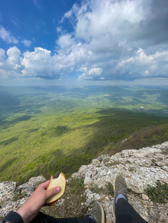 a person eats bread on a trip hiking nature mountainsの写真素材