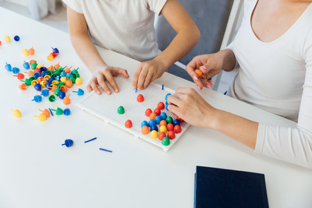 a boy with a female psychologist in the office plays educational gamesの写真素材