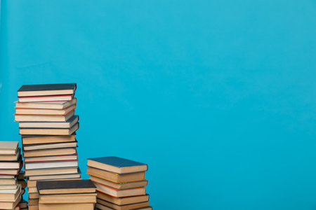 science education stack of books on a blue background teaching literacyの写真素材