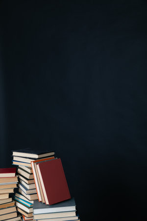 stack of books on a black background science education culture trainingの写真素材
