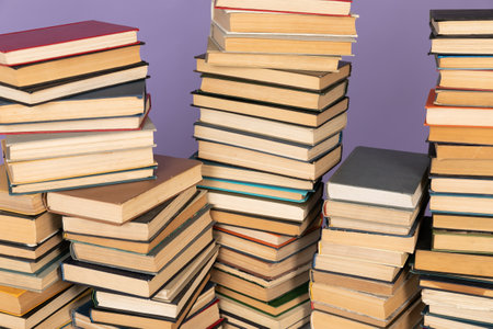 stack of books on a purple background science education culture trainingの写真素材