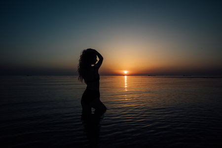 silhouette woman on the sea on the beach rest walking journeyの写真素材