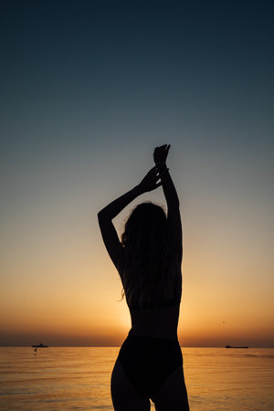 silhouette woman on the sea on the beach rest walking journeyの写真素材