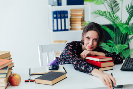 business woman office worker in the office at a desk with books in the office