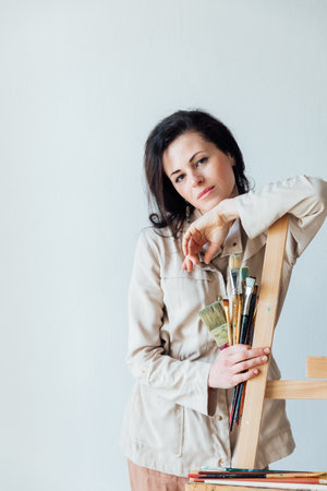 a woman artist stands at an easel with tasselsの写真素材