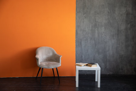 Chair and coffee table in the interior of a gray orange roomの写真素材