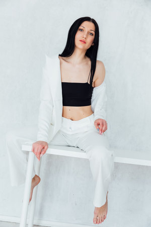 Beautiful fashionable brunette woman in white business suitの写真素材