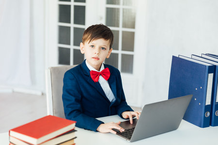 student sitting in the classroom at a laptop with books in the office education online programmingの写真素材