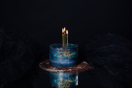 beautiful cake with three candles standing on the table holiday birthdayの写真素材