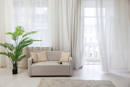 Interior large green flower in a bright room with sofa