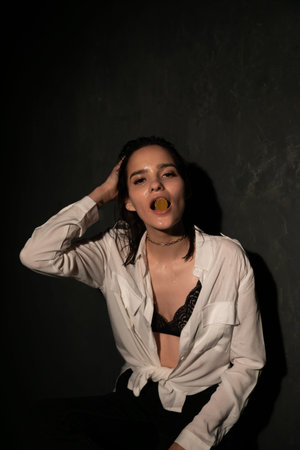 Portrait of a beautiful woman in a white shirt and black bra