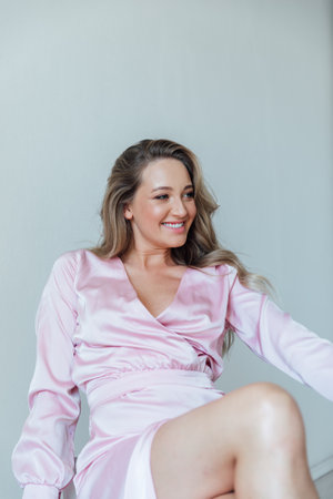 a beautiful woman in pink dress laughsの写真素材