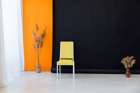 yellow chair with decorative colors on a black background interior in the roomの写真素材