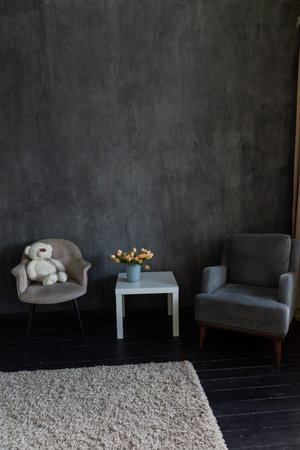 armchair coffee table soft toy flowers in the room interior