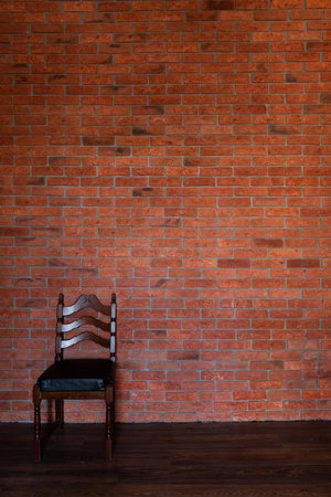 chair against the brick wall in the room pieces of furnitureの写真素材