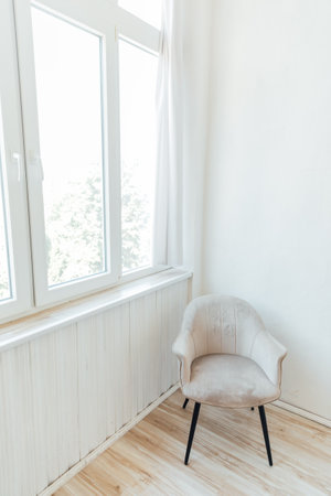 one armchair stands by the window in a bright roomの写真素材