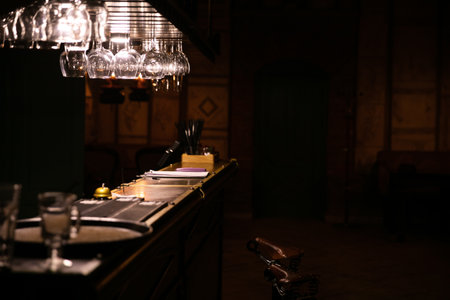 bar counter with plenty of wine glasses on topの写真素材