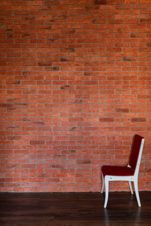 one chair in the room against the background of a brick wallの写真素材