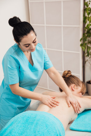 masseur does back massage healthy back relaxation healing osteopathyの写真素材